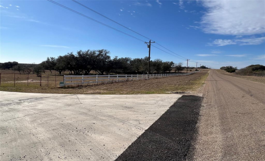 This is the view in front of the entrance standing on Harmon Road looking west.  Beautiful white fence all along the entance.  The entire subdivision is copletely fenced in.