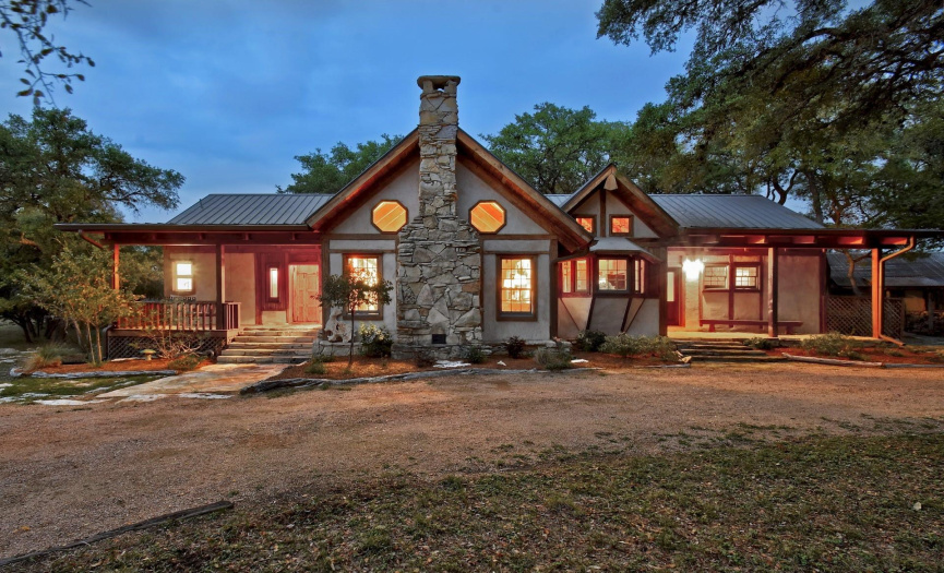 Twilight- Front side of the main house. Beautiful hill country setting. Multiple outdoor spaces.
