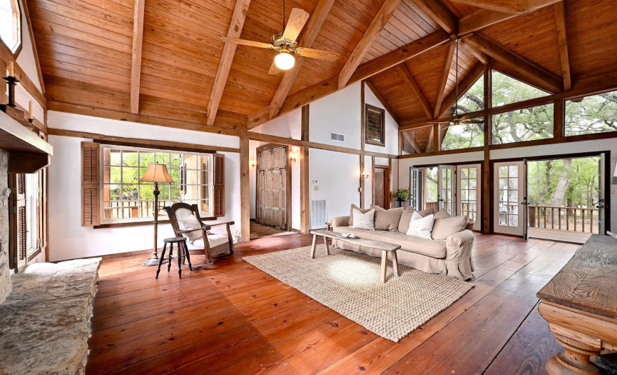 Living Room- Multiple french doors lead out to the back deck & patio. Beautiful views of nature. 