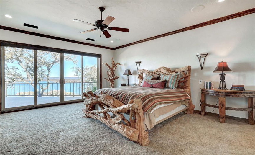 Large primary bedroom has access to the balcony, and those lake views!