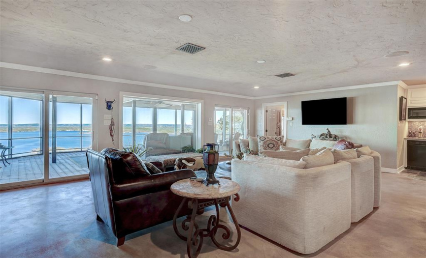 Living room downstairs, with large screened-in porch and lake views! 