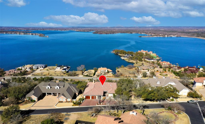 Panoramic views of Lake LBJ from this gorgeous Spanish style lake home, situated high on a bluff in Horseshoe Bay. 