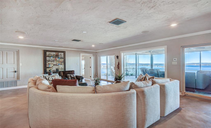 Large living room downstairs, connected to large screened-in porch, and stunning views!
