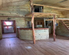 Picture of one of the two loft areas which are very similar and shows entrance for the kitchen. Cabin could be very cozy with just a small amount of work.