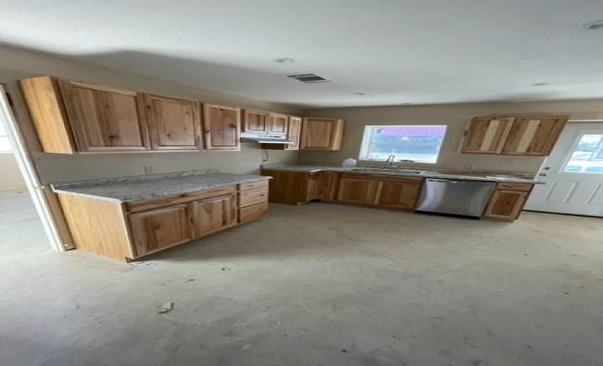 Nice compact open kitchen, appliances yet to be installed. Lots of cabinet space for storage.