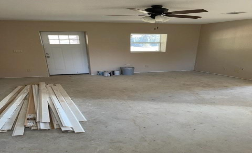 Large living area which is very open to kitchen area. Floor molding on floor to be installed after flooring is put down.