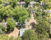 Ariel photo shows main house, oversized garage (or convert to back house granny flat or garage apartment or maybe an awesome workshop) already has electric. This is a HUGE LOT, it consumes this photo. Come tour! _1 ACRE FOR SALE: 2923 Pecan Springs Rd., Austin, Tx 78723
