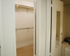 The left door opens onto a walk-in closet that stretches the length of the entire bath area.  The door on the right conceals the private tub and toilet enclosure.