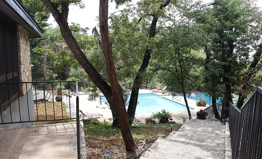 The larger upper pool, left, is outfitted with a volleyball net; a waterfall spills into the lower pool.