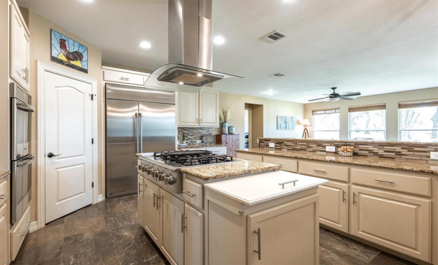 The gourmet kitchen will appeal to the chef in you with the 6-burner gas cook top, double oven, spacious granite counter tops, and two walk-in pantries.