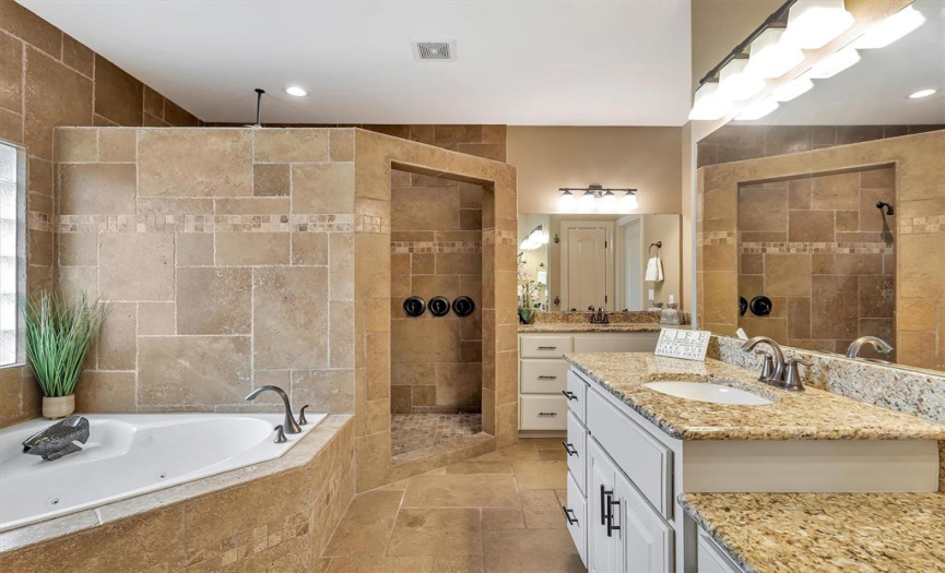 Add a jetted, soaking tub, oversized walk-in shower with THREE shower heads and granite seat, comfort-height dual vanities and you'll never want to leave.