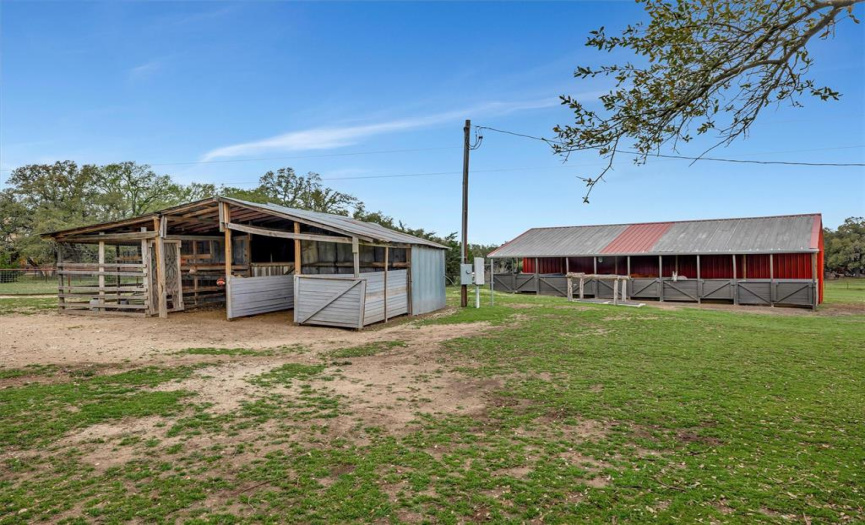 The front barn is a chicken coop while the back barn has five horse stalls. Behind the stalls is a large storage area while on the far side is hay storage.