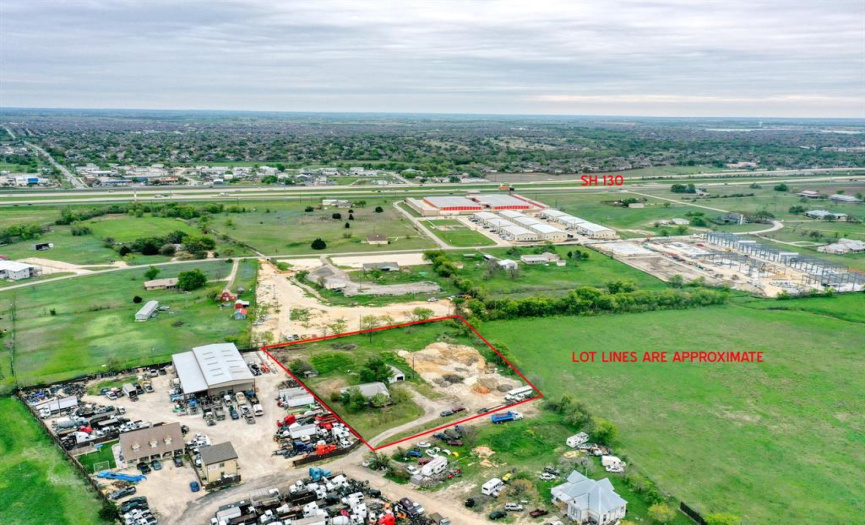 Aerial photo showing 2 Prime acres of unrestricted property with endless possibilities, surrounded by existing commercial properties.