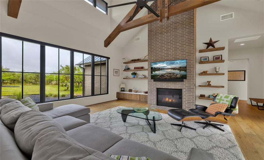 Family room with view of the floating shelves and wood beams. 