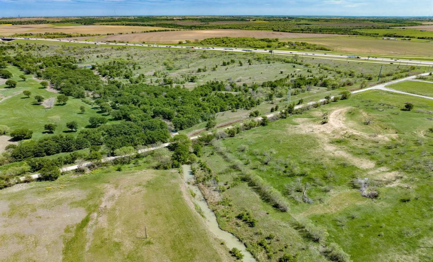 Another arial view from the west, the 54.392 acres runs roughly from the Old US Hwy 77 or 3102, from the tree line to the I35 access road in the distance.  