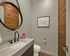 Half bath with wood accent wall. 
