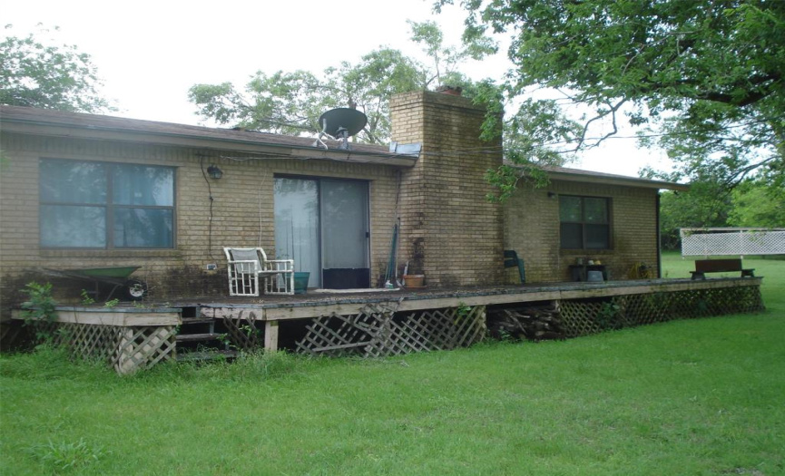Back of house with deck