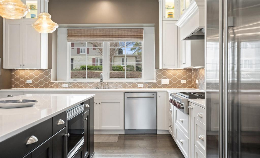 The stainless steel appliances in this kitchen include high-end brands such as Sub Zero, Wolf, and Asko