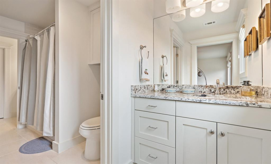 2 of the upstairs bedrooms share a jack and jill guest bath, with each room having its own private vanity space
