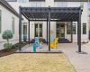A backyard retreat that's fit for a king, this large, pergola covered back patio is where you can unwind and relax after a long day, or escape with friends for a summer barbecue