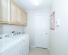 Laundry room-pocket door leads to an extra storage room