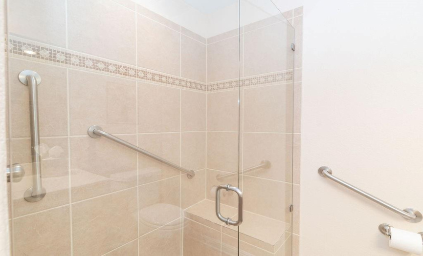 Walk-in shower in hall bath with built in shelf