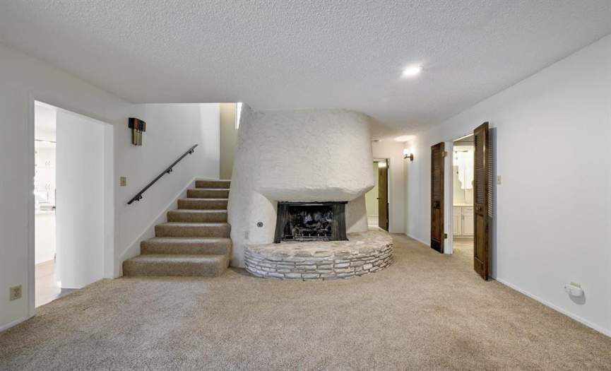 Living room with unique stucco fireplace