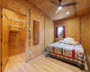 The primary bedroom offers recessed lighting, a modern ceiling fan and gorgeous natural wood doors.