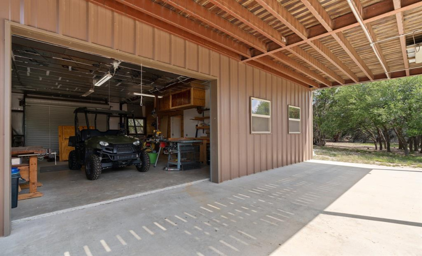 A large cement patio stretches out under the 2nd floor balcony in front of the workshop, providing shade for working on your projects and a nice outdoor seating and dining area.