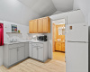 The lovely kitchenette offers updated contemporary cabinetry below and comes with a fridge, microwave, and sink.