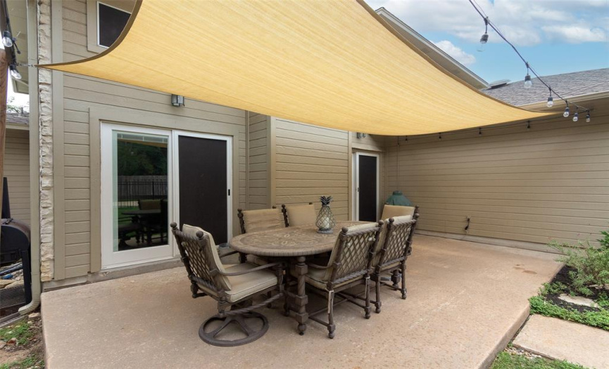 Covered patio has two sets of sliding doors for both kitchen and family room access.