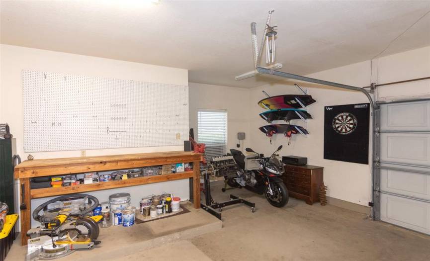 Workbench and oversized garage provide room for projects and toys.