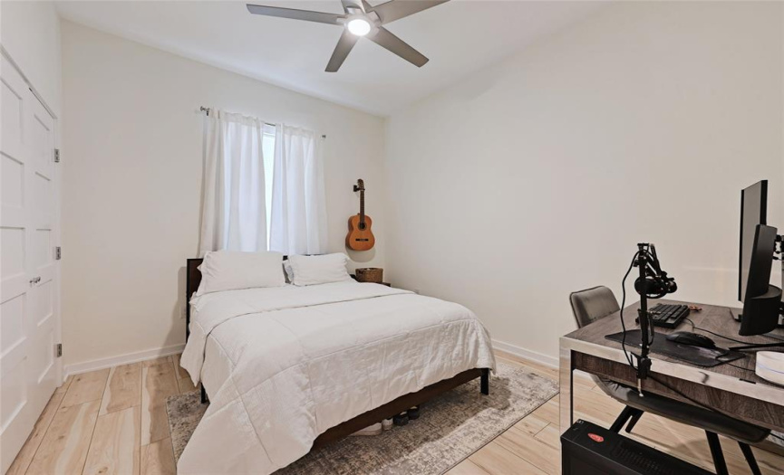 Bedroom with Vinyl Plank Floors, High Ceilings, Step in Closet, Window Treatments