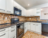 Kitchen with tile backsplash and granite counter tops
