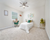 Adorable secondary bedroom with new carpet and lighting fixture