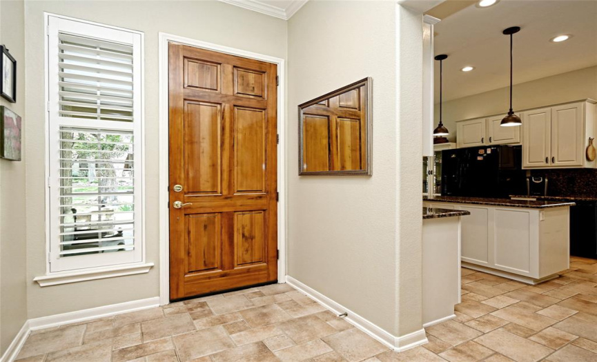 A gorgeous 8' wood front door opens onto tile floors in this Trinity floor plan home.