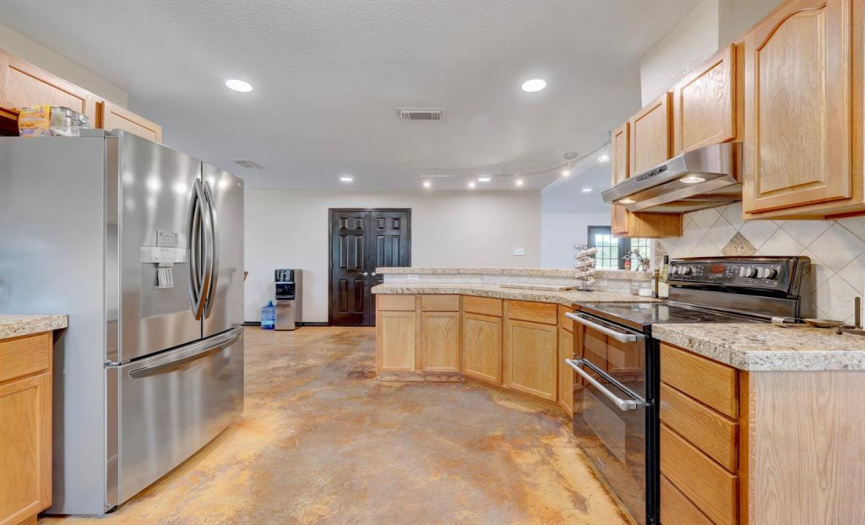 The kitchen is equipped with stainless steel appliances, including a range with double ovens.