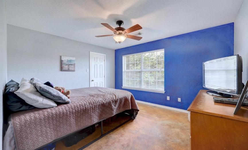 The front/second bedroom is well-sized with a ceiling fan and a walk-in closet.  That blue paint is chalkboard paint!  How fun!