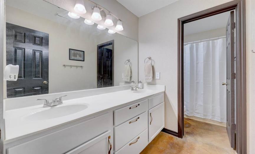 The shared guest bath offers a dual vanity and a separate wet room with a tub/shower combo. 