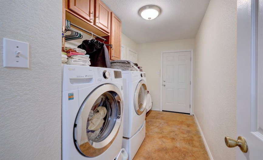 Nice-size laundry room with built-in cabinetry. This room also has the water heater in it and access to the left side of the home.  Water heater was replaced in April 2022.
