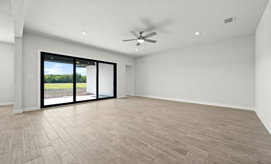 Large family room with large 12' sliding glass doors to the back patio.