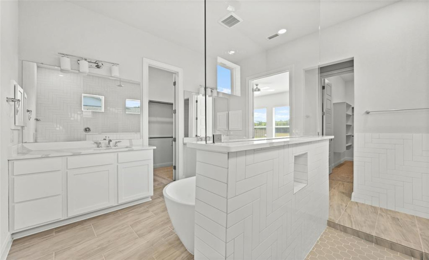 Luxury master bathroom built in niche in the shower wall and lots of cabinet space with medicine cabinets.