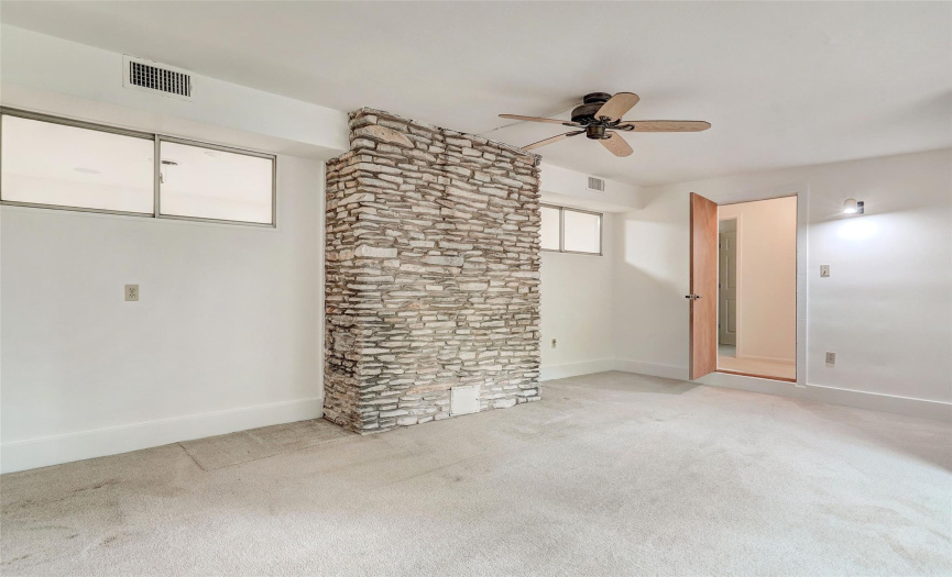 The back patio was enclosed to create this bedroom and more space for a growing family. The stone wall is the back of the fireplace hearth. 