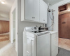 The utility room is located close to the kitchen and has a separate storage room next to it. The washer and dryer convey.