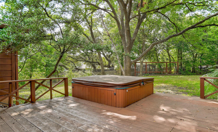The hot tub spa is operational and is surrounded by a wooden deck for the enjoyment of all. 