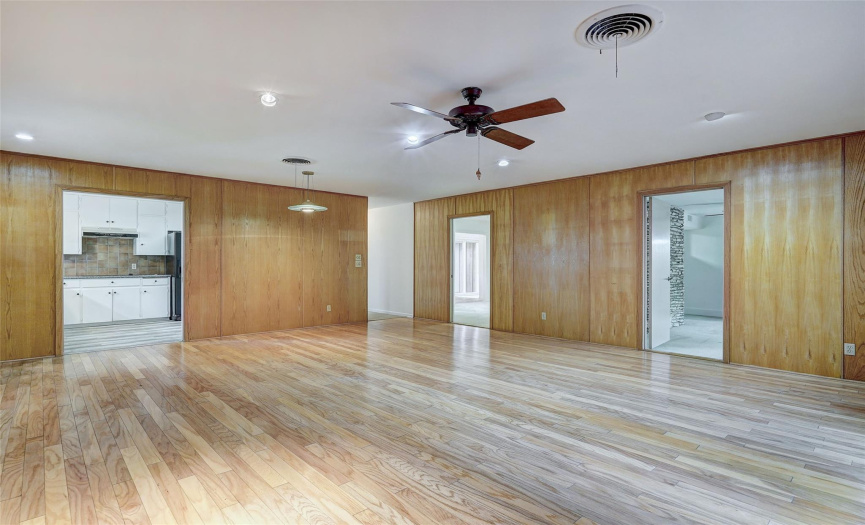 The family room has access to the kitchen, living room and bedroom, in addition to the front door. A ceiling fan helps to keep it cool and breezy. 