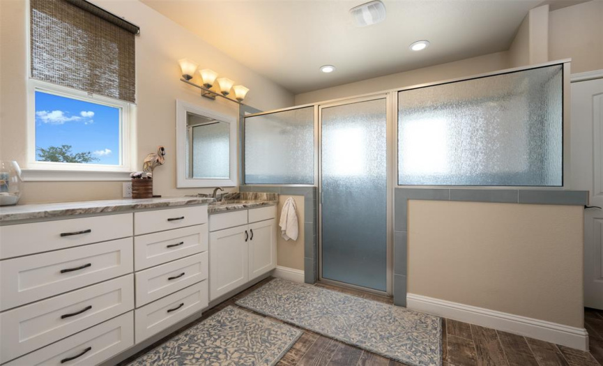 Huge walk-in shower for two with gorgeous tile and double shower heads.