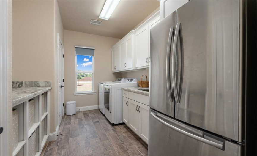 Mudroom/laundry room convenient to the primary suite. Utility sink, room for a fridge and so much storage.