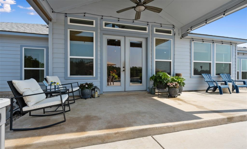 Enjoy the shade provided by the covered porch, located just off the back of the home.  Party lights will convey.