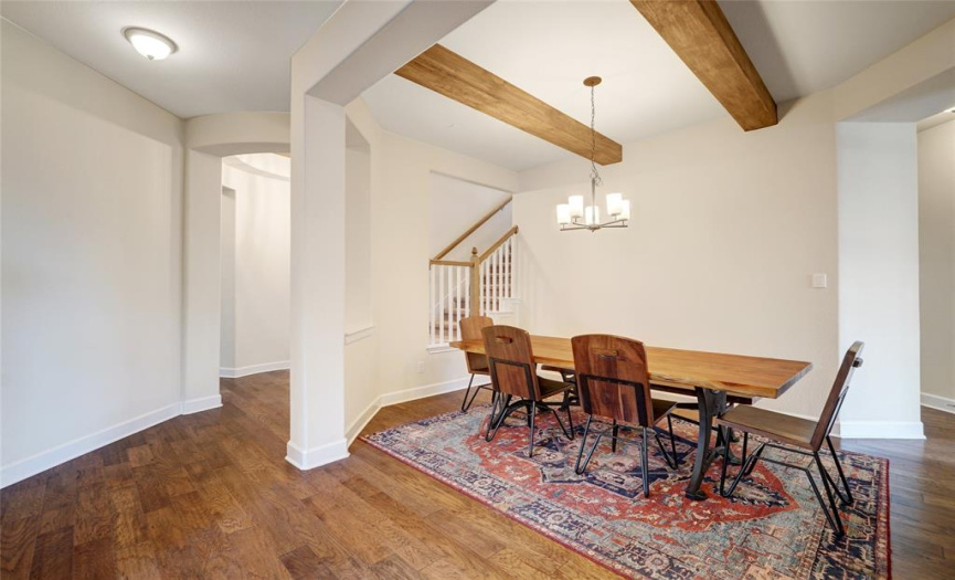 Formal dining room with decorative wood beams